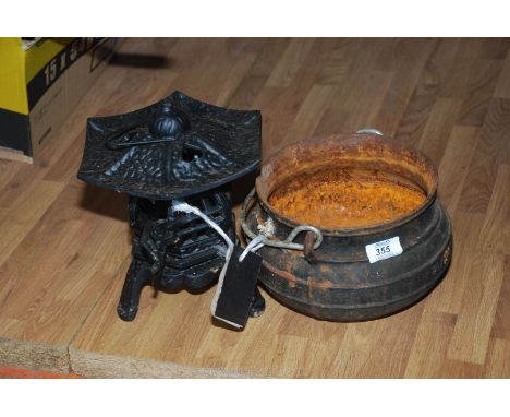 A cauldron and tea light holder. 