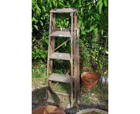 A vintage 4 rung step ladder.