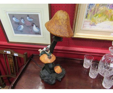 A figural lamp of a fairy and toadstools