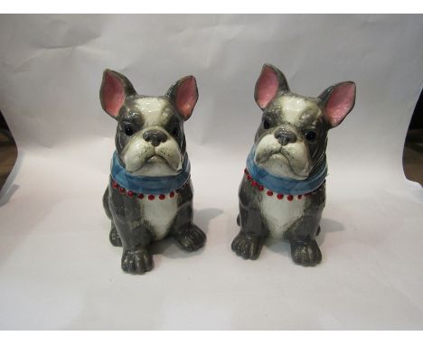 A pair of ceramic bulldog biscuit barrels, 27.5cm tall
