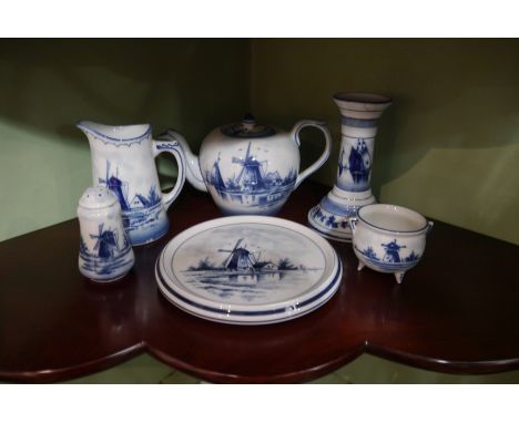 A selection of Delft blue and white ceramics including teapot, jugs, egg cups, candlestick, etc