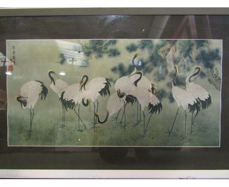 An Oriental print depicting cranes, framed and glazed, 31cm x 62cm