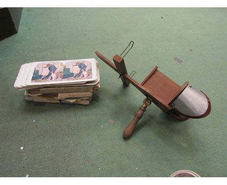 A vintage stereoviewer with cards including topographical and controversial