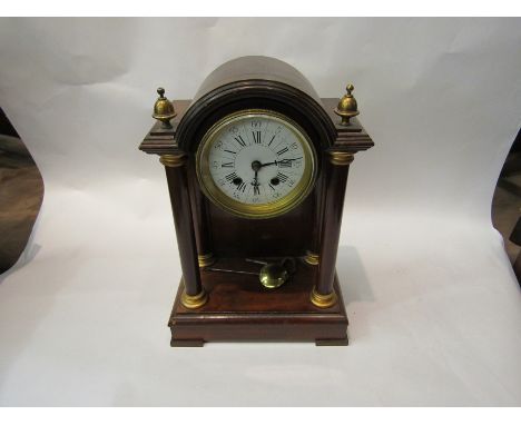 A late 19th Century four pillar mantel clock with white enamel face 35cm tall