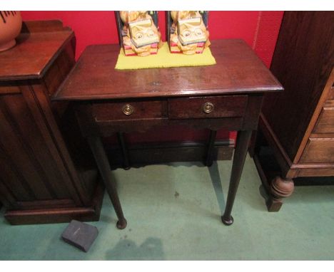 An early 19th Century country oak lamp table the two frieze drawers and shaped apron on pad foot tapering leg supports. 69cm 