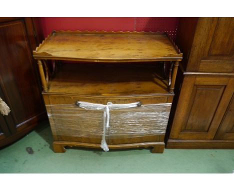 A Georgian influenced reproduction mixed wood double-width side cabinet with wavy gallery to the tray top, open shelf support