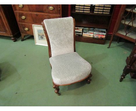 A circa 1860 rosewood slipper chair with carved acanthus leaf decoration on scroll feet and ceramic castors