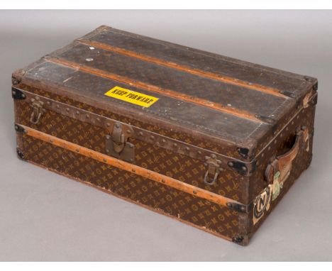 VINTAGE LOUIS VUITTON STEAMER TRUNK an early 20thc steamer trunk, the monogrammed case with wooden bars, metal studs and brac
