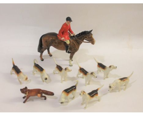 BESWICK HUNTING SET including a Beswick Huntsman on a brown Horse, Model No 1484. Also with 8 various Beswick hounds in vario