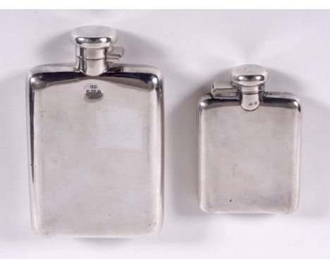 TWO SILVER SPIRIT FLASKS including a large rectangular shaped spirit flask with a hinged lid, marked for Birmingham 1915. Als