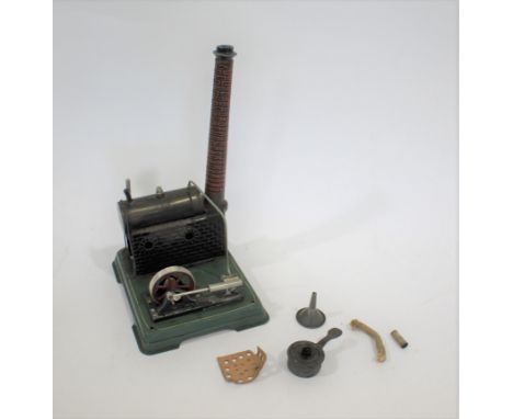 MODEL STEAM ENGINE a tin plate stationary model of a horizontal steam engine with fly wheel and chimney. Also with a burner, 