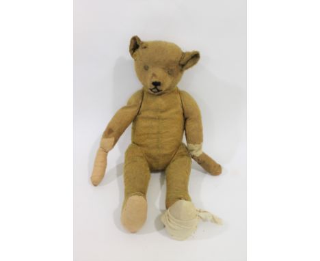 EARLY STEIFF TEDDY BEAR with elongated limbs and hump back, in generally poor condition and foot detached. 27ins (69cms) high