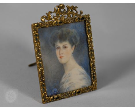 A late Victorian/Edwardian portrait miniature on ivory of a young lady in white gown with blue floral corsage, 6.5 x 5.5 cm, 