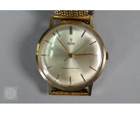 A gentleman's 9ct Tudor wristwatch, the champagne dial with gilt baton markers and sweep second hand, on expanding gilt strap