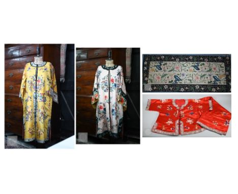 A vintage traditional Chinese yellow silk long summer jacket or robe embroidered with flowers, the sleeves with figures in ga