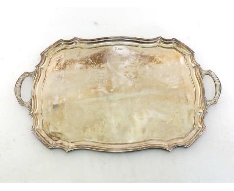 A silver two-handled tray of shaped rectangular outline with moulded border, by Walker & Hall, Sheffield, 1939, 66.4 cm. wide