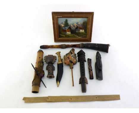 An interesting collection of Indonesian and other artefacts, including a wooden puppet head, a bamboo pipe with applied figur