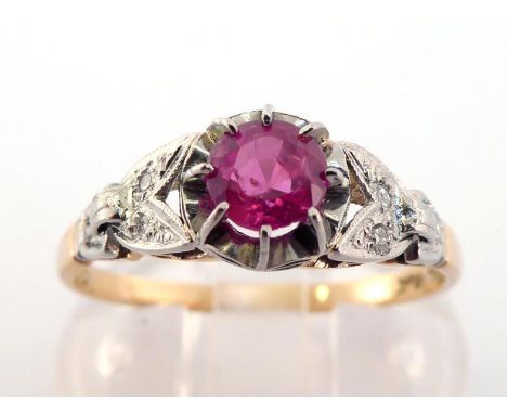A ruby and diamond ring, the central round cut ruby 4.6mm, claw set above illusion set diamond shoulders, the shank stamped '