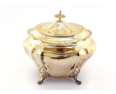 A late Victorian silver bellied oval tea caddy by James Dixon & Son, Sheffield, 1900, on decorative scroll feet, gilt interio