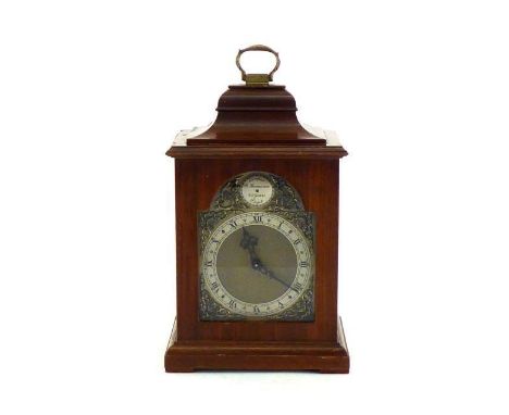 A mahogany cased reproduction mantel clock in the 18th. century manner, the dial with silvered chapter ring, matted centre an