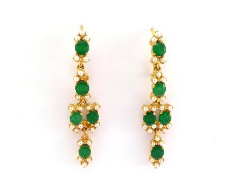 A pair of jade and seed pearl pendant earrings, the facetted round cut jade stones each 5.2mm diameter, each in a surround of