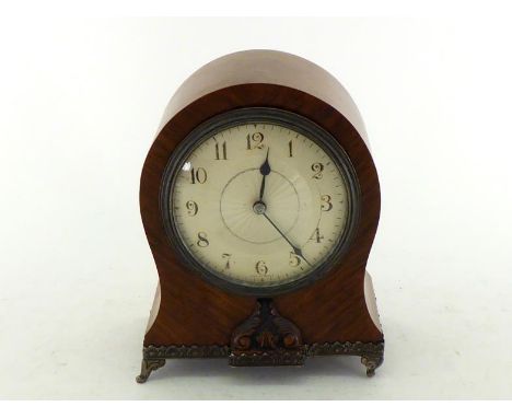 A balloon cased French walnut mantel clock on gilt brass  feet and base gallery trim, engine turned radiating finish to the o