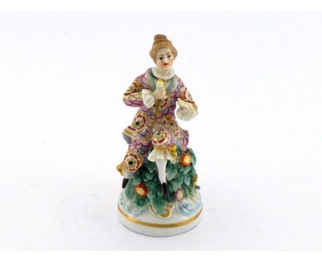 A small ceramic scent bottle very well modelled as a lady seated on a leafy mound, her head the stopper, gold anchor mark to 