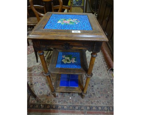 A three tier tile shelf occasional table on turned supports with carved detail to square surrounds, 38cm square x 74cm high