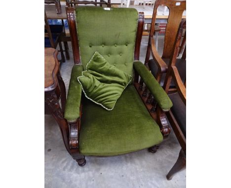 A green upholstered low and deep button back armchair