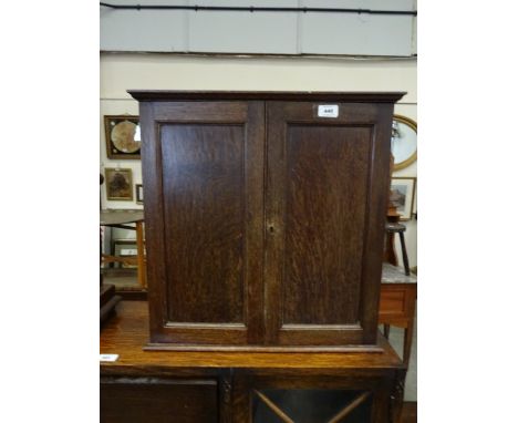 A small oak wall hanging two door cabinet to two shelf interior, 54.5cm x 20cm x 56cm high