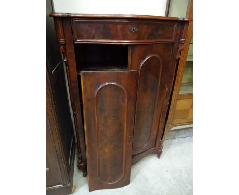 A pretty serpentine front mahogany cabinet with panelled doors to four shaped shelf interior, drawer to top, 92cm x 52cm x 13