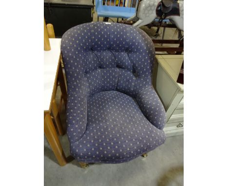 A blue button upholstered ladies nursing chair on turned front legs