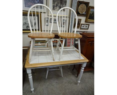 A pine tile topped kitchen table together with three hoop and stick back chairs