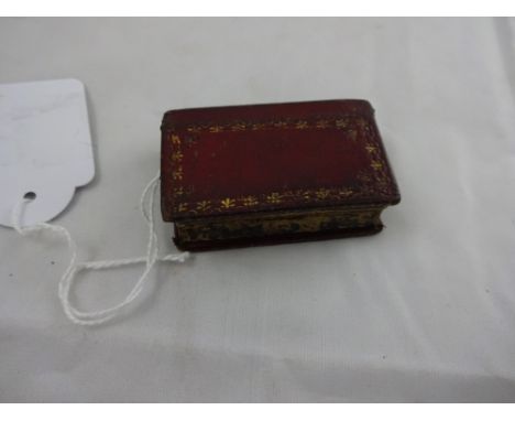 An antique leatherbound book shapped novelty snuff box