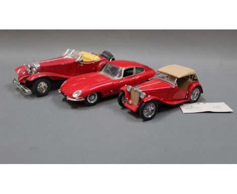 A group of three Franklin Mint diecast model cars: a Mercedes 500K Special Roadster, a 1948 MGTC, and a 1961 Jaguar E-Type Co