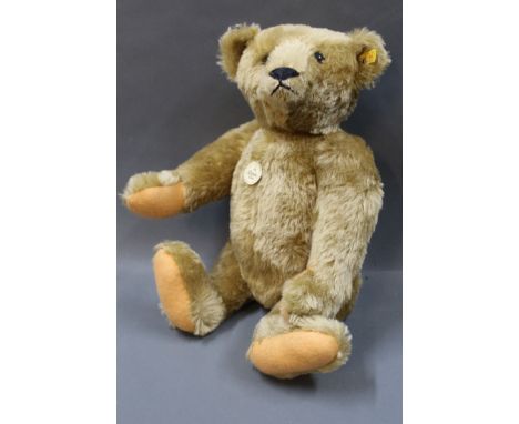 A Steiff Classic 1906 replica teddy bear, having button and label to its ear, working growler mechanism, and measuring 51cm h