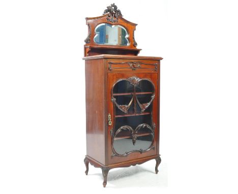 A late 19th centuryy Art Nouveau style mahogany bookcase pier cabinet. With pierce carved floral top, bevelled edge glass cen