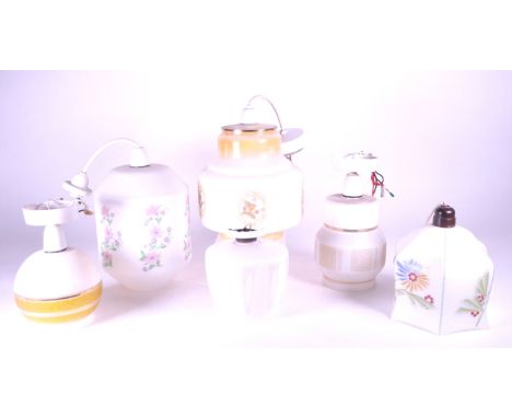 A collection of six vintage 20th century ceiling lights. Each having frosted white glass shade with designs.