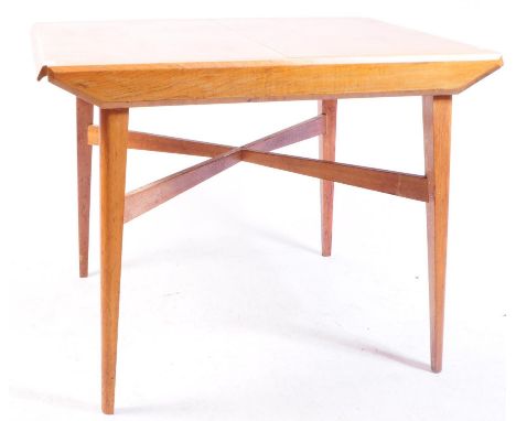 Lebus Link Furniture - British Modern Design - A mid century teak wood dining table. Raised on tapering legs with upper cross