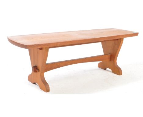 A vintage late 20th century teak wood bench / coffee table. The table raised on block supports united by a stretcher. The top