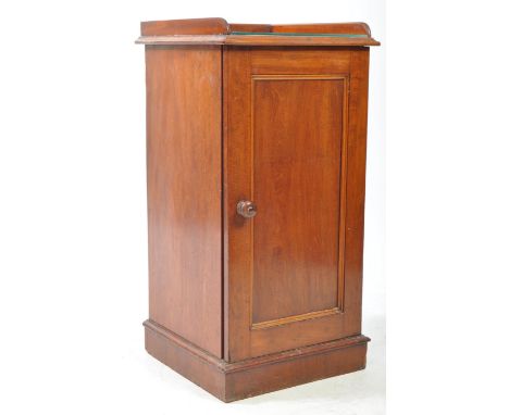 A 19th century Victorian mahogany bedside cabinet / pot cupboard. The pot cupboard raised on a plinth base, with gallery surr