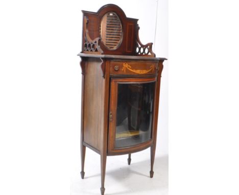 An early 20th century Edwardian mahogany inlaid pier display cabinet. The cabinet raised on tapered supports, having single c