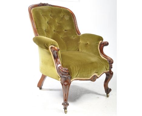 A 19th century Victorian walnut library armchair. The chair having carved palmette and acanthus leaf pediment top rail over a