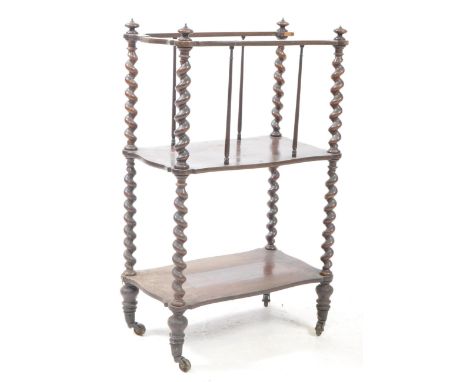 A 19th century rosewood barleytwisetetagere - whatnot canterbury stand. Raised on brass castors with barley twist columns to 