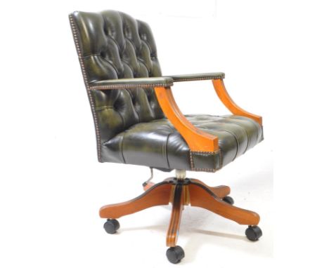 A late 20th century green leather office swivel desk armchair. Button back rest and seat, with reeded sloping elbow rests, st