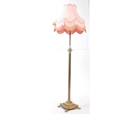 A 19th century brass Corinthian columnar standard lamp. The lamp raised on lions paw feet with acanthus leaf detail, under a 