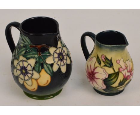 Two modern Moorcroft floral decorated tubelined jugs, one dated 1997, the second dated 2002 and numbered 9/250, height 15cm a