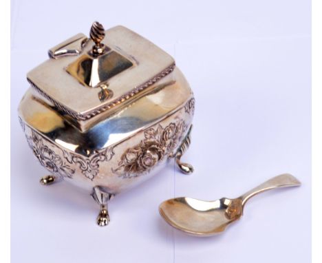 A late Victorian hallmarked silver tea caddy of rounded rectangular form embossed with floral sprays, Birmingham 1900, also a