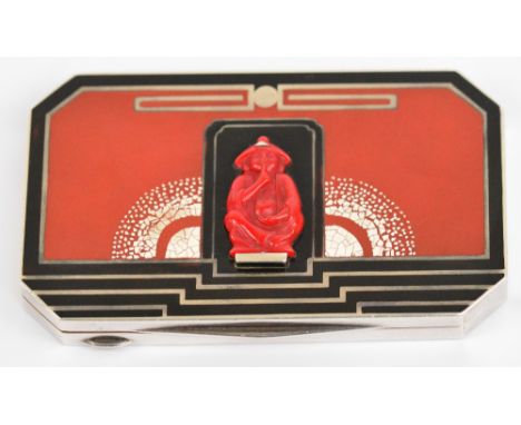 An Art Deco French silver and enamel decorated compact of rectangular form with canted corners, the hinged lid set with an ap