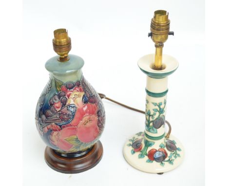 Two modern Moorcroft lamp bases; one of baluster form decorated with birds amongst apples and grapes, height including turned